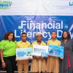 Some members of Unity Bank staff pose for a shot with some of the students and staff of NYSC Demonstration Secondary School, Calabar after the financial literary day training.